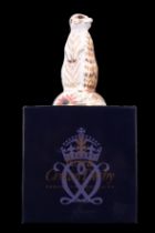 A Royal Crown Derby meerkat paperweight, having a gold stopper and boxed, 13 cm