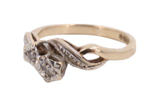 A 1990s twist-set two-stone diamond ring, the small stones illusion-set on an open interlaced double