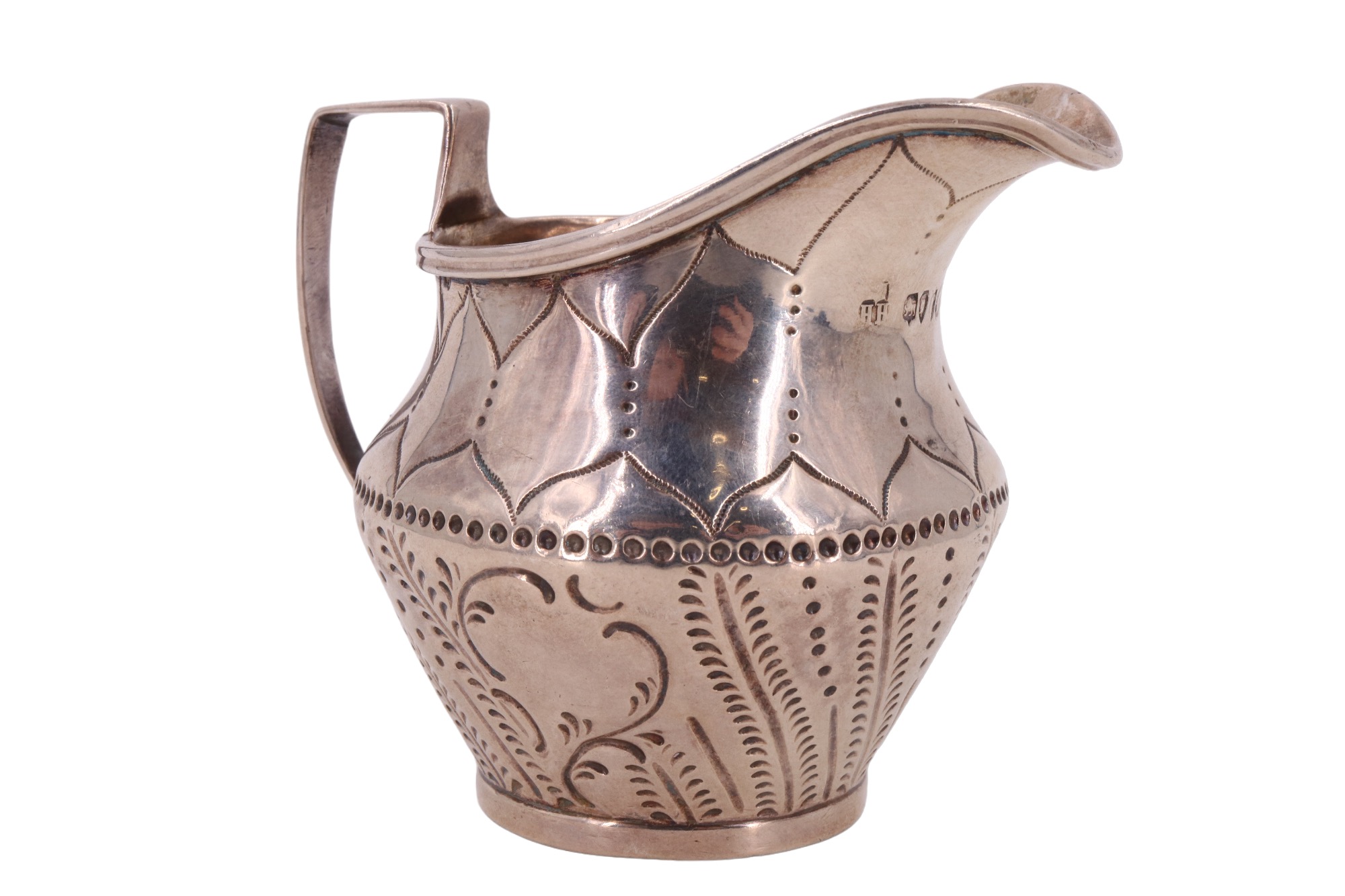 A Victorian silver cream jug, decorated with engraved stylized fern leaves, retailed by Hinks &
