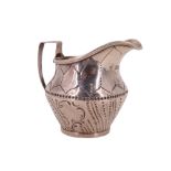 A Victorian silver cream jug, decorated with engraved stylized fern leaves, retailed by Hinks &