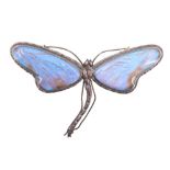 A large vintage white metal dragonfly brooch, its wings those of butterflies set under glass, 8.3