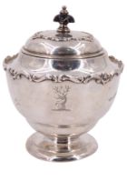 An Edwardian silver tea caddy, of shouldered ovoid form and having a hinged cover and applied