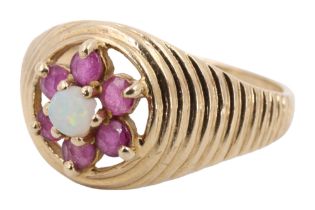 An opal and ruby daisy set ring, comprising a central opal surrounded by six 2.5 mm rubies, open set