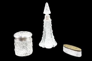 An Edwardian silver lidded cut glass dressing table jar together with a silver collared spire-form