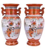 A pair of Meiji period Kutani porcelain two handled vases, each having a panel decorated with two