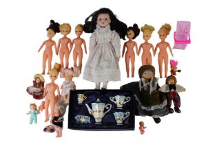 A vintage porcelain headed doll together with a group of composition dolls, costume, and a boxed The