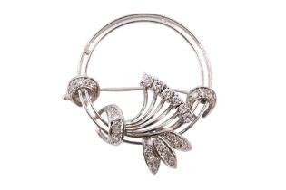 An Art Deco style diamond floral brooch, comprising an annulus of openwork and pellets, overlaid