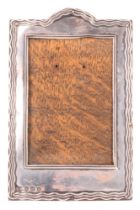 A 1920s diminutive silver-faced photograph frame, having an oak back and stay, W J Myatt & Co,