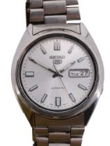 A Seiko 5 stainless steel wristwatch, having an automatic movement, brushed silver face, baton hands