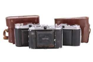 Four early 20th Century cased folding roll film cameras, comprising a Zeiss Ikon Nettar, Frankar