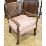 A 1930s cane backed oak boudoir armchair, 71 cm