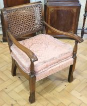 A 1930s cane backed oak boudoir armchair, 71 cm