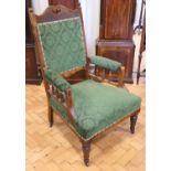 A Victorian upholstered and carved open-arm lounge chair