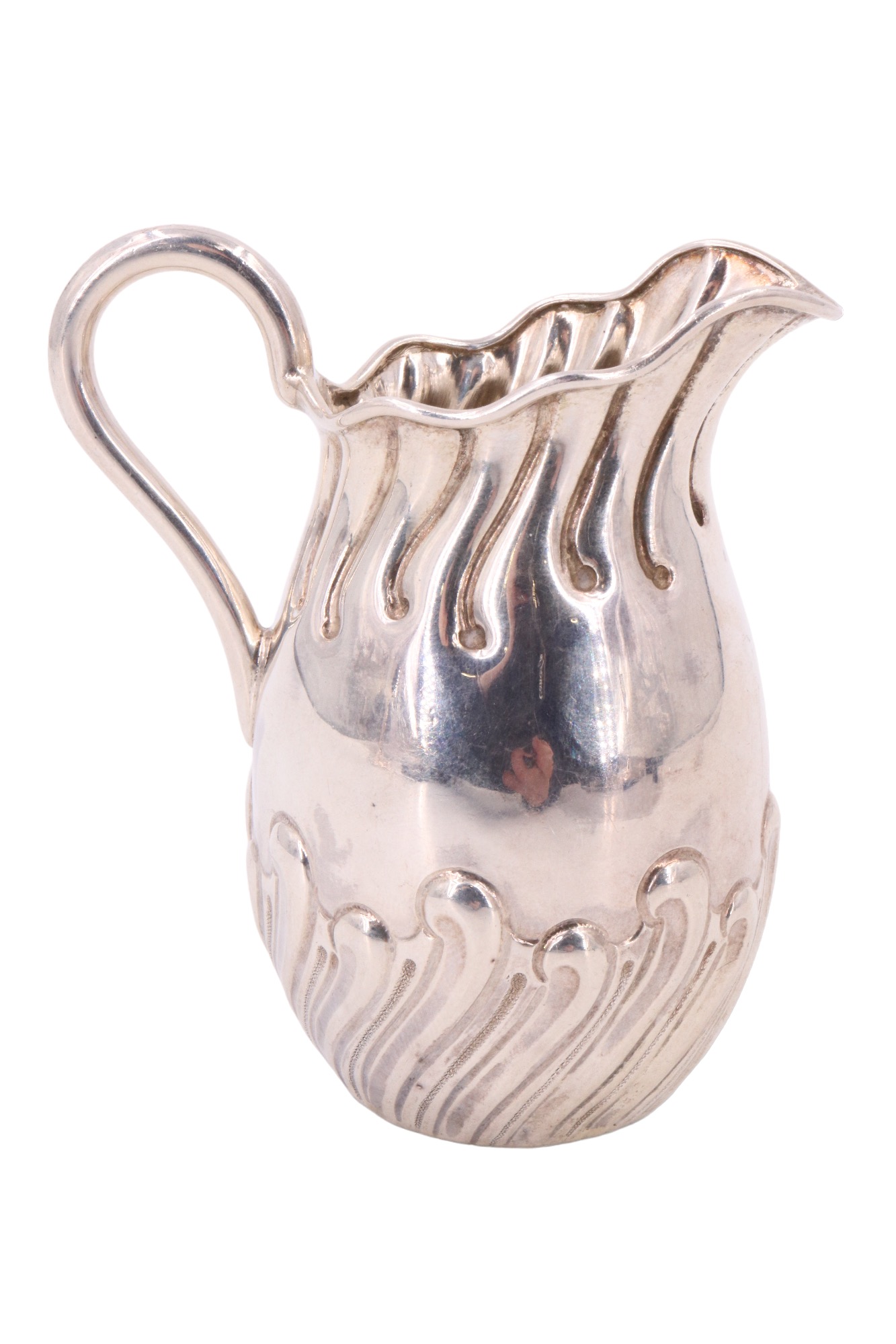 A diminutive Victorian silver cream jug, decorated with embossed stylized honeysuckle reeding, Atkin
