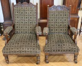 A pair of Victorian upholstered and carved walnut lounge armchairs