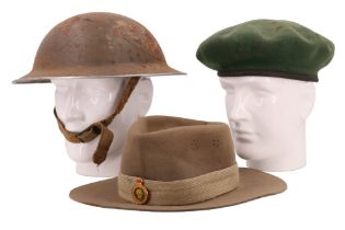A Second World War helmet and two caps
