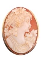 A large Italian shell cameo brooch. the cameo depicting a Bacchanalian youthful female profile bust,