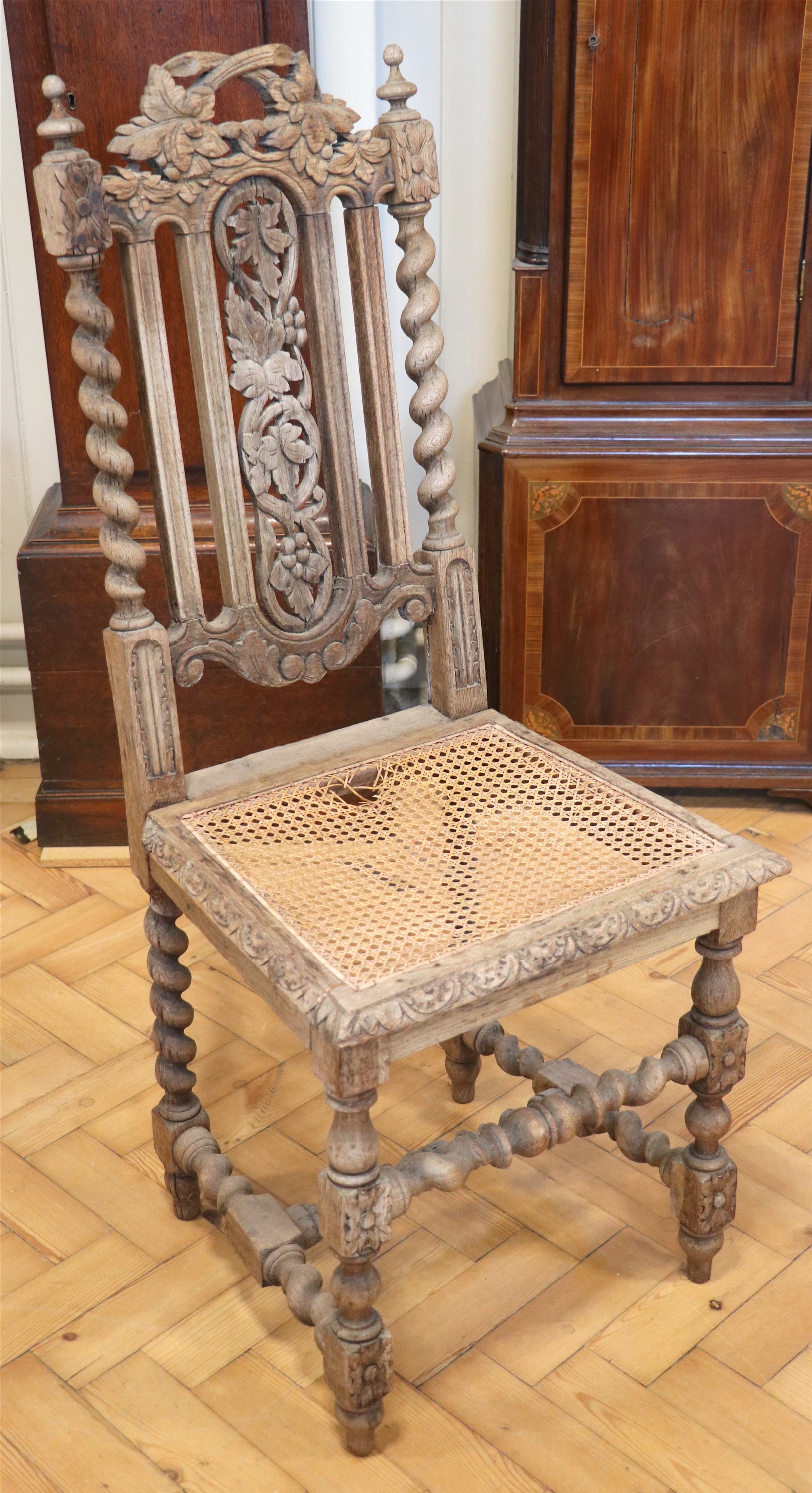 A late 19th / early 20th Century William III style carved oak and cane seated back-stool