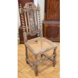 A late 19th / early 20th Century William III style carved oak and cane seated back-stool