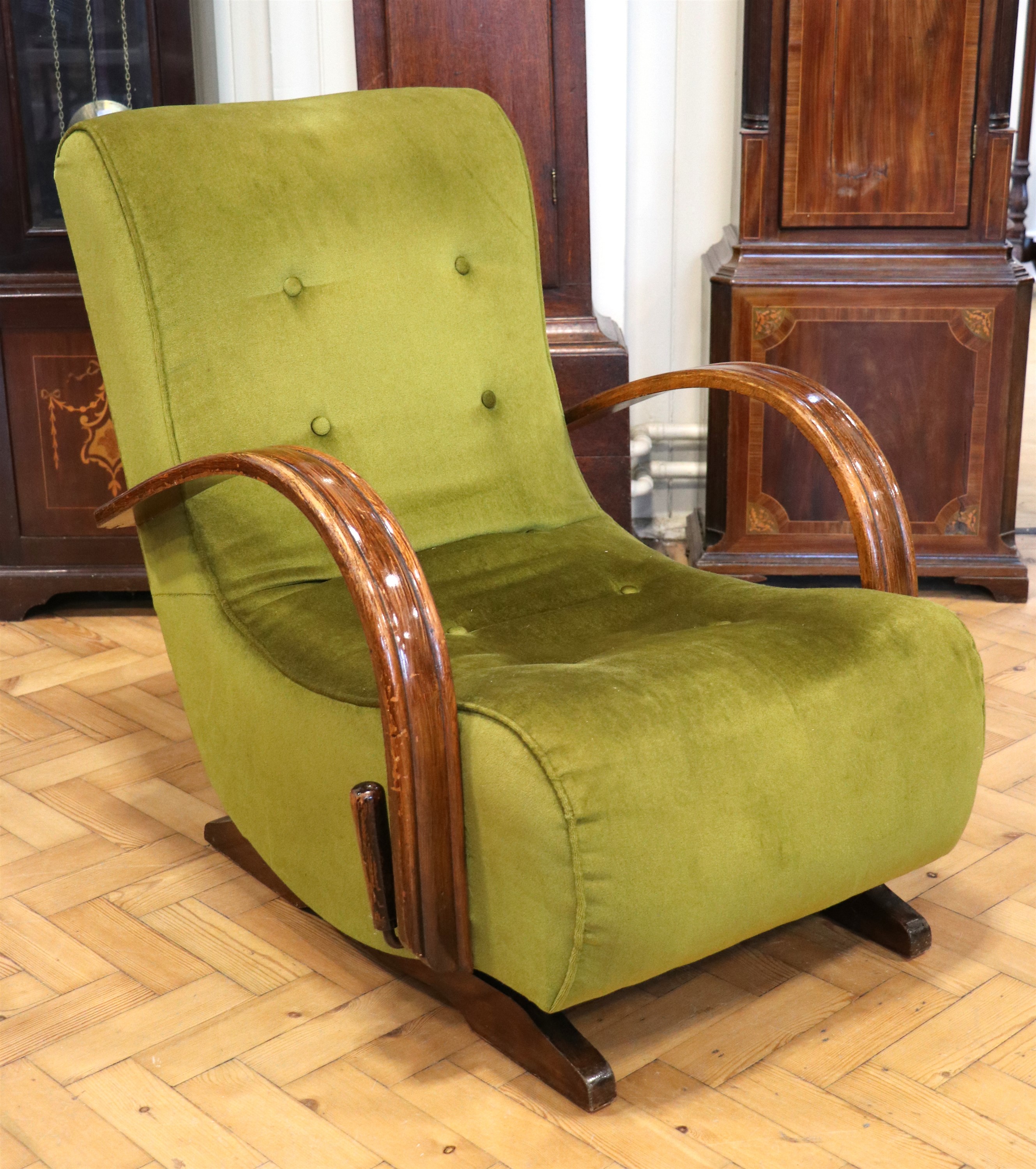 A 1930s Moderne upholstered rocking armchair, having a lever operated clutch