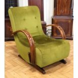 A 1930s Moderne upholstered rocking armchair, having a lever operated clutch
