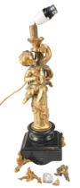 A late 19th / early 20th Century gilt metal and polished black marble figural lamp, in the form of a