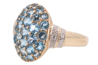 A contemporary blue spinel and white stone dress ring, having a convex oval face pave set with 29