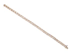 A contemporary diamond and 9 ct gold bracelet, comprising gold 'S' links alternatively separated