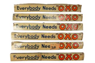 Six vintage "Everybody needs OXO" printed tinplate advertising plaques, 48 cm long