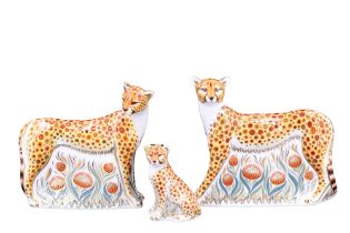 A family group of three Royal Crown Derby cheetah paperweights comprising 'Cheetah', Cheetah