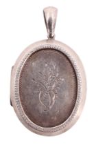 A Victorian white metal pendant locket, oval with recessed faces, the obverse bearing a vacant