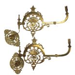 A pair of Victorian gas wall lamps having brass brackets, converted