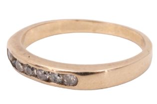 A diamond finger ring, having a line of seven channel set 2 mm brilliants, between plain shoulders