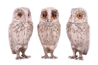 A trio of silver novelty condiments by Garrard & Co, each cast in the form of an owl with glass eyes