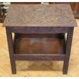 A Victorian Scottish carved mahogany occasional table, the carved top incorporating cross and