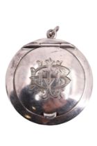 A George V silver fob powder compact, of lenticular form and bearing an engraved monogram, Levi &