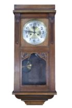 A 1920s / 1930s walnut wall clock, 79 cm