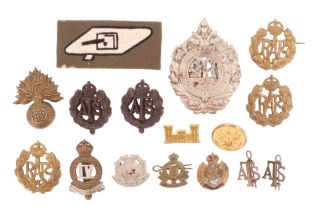 A small group of largely British military insignia including a Royal Tank Regiment embroidered arm