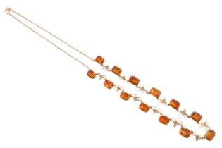 A Victorian citrine and seed pearl necklace, comprising 13 adorsed graduated radiant cut stones,