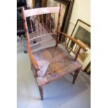 Arts & Crafts beechwood elbow chair with spindle back and sides, rush seat and turned supports