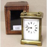 Gilt brass cased single train carriage clock with enamel dial, having Roman numerals and original