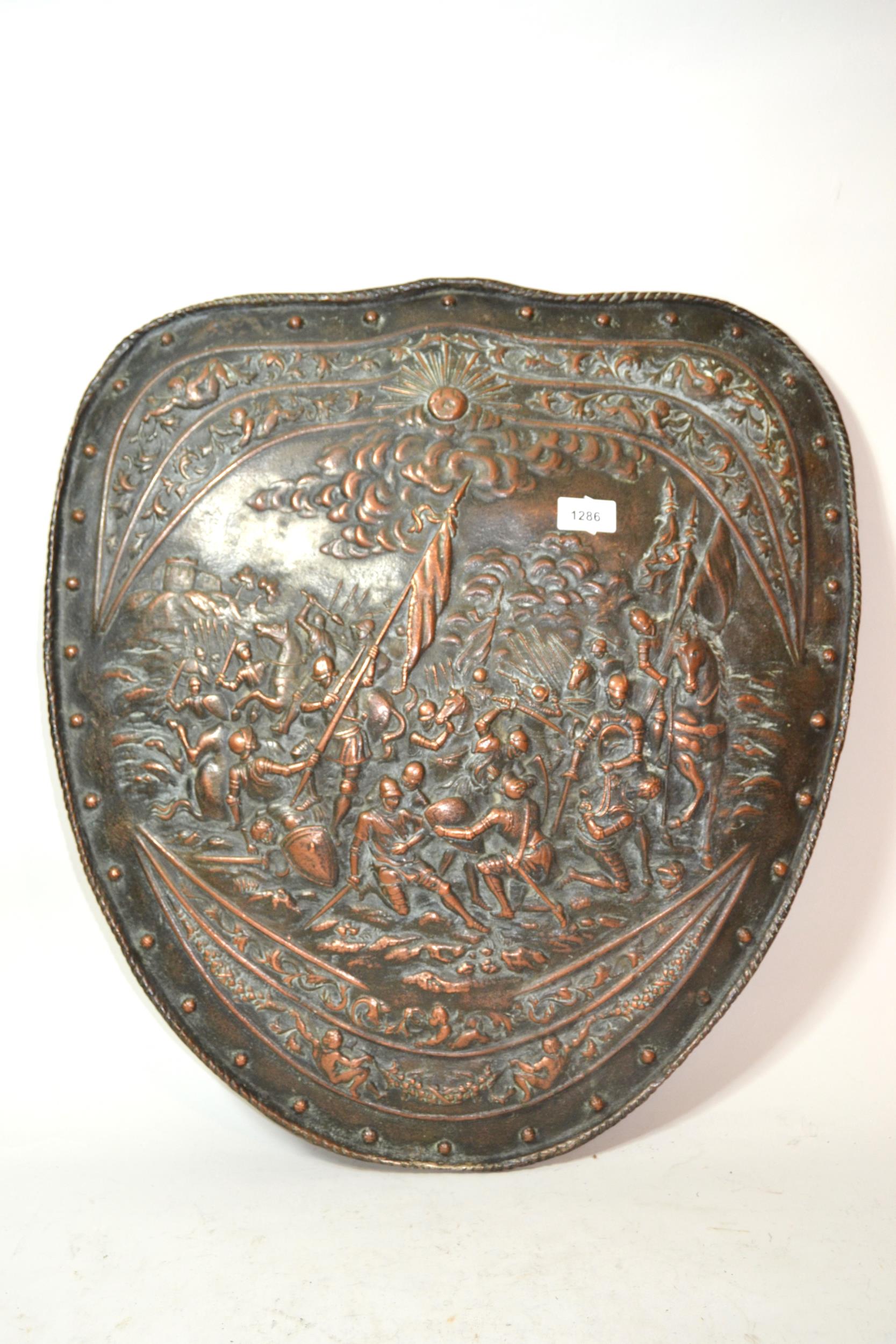 Early 20th Century patinated copper wall plaque decorated with a battle scene in the form of a