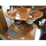 Small reproduction mahogany circular pedestal dining table, the crossbanded tilt top above a