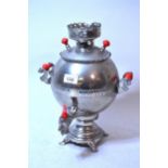 Metal and red plastic mounted samovar presented by Mikhail Gorbachev to Sir Bernard Ingham, 33.5cm