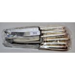 Set of eight silver handled dinner knives and a set of eight matching silver handled dessert