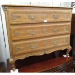 French oak straight front chest of three carved moulded drawers, raised on cabriole supports,