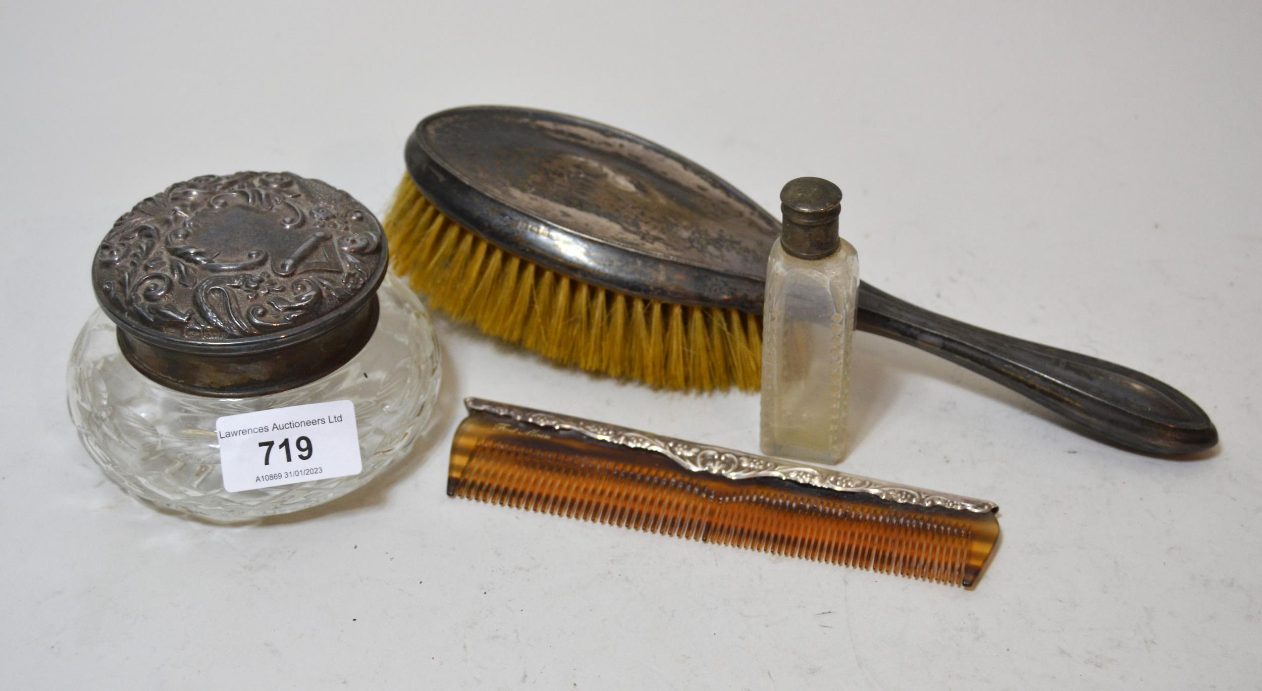 Silver topped dressing table jar with embossed cover, silver backed brush and comb and a cut glass