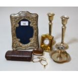Silver embossed photograph frame, silver gilt miniature clock, pair of silver candlesticks and a