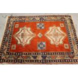 Indo Persian rug of twin medallion design with multiple borders on a red brick ground, (some wear)