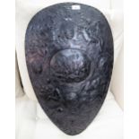 Late 19th / early 20th Century dark patinated metal and relief decorated shield form wall plaque